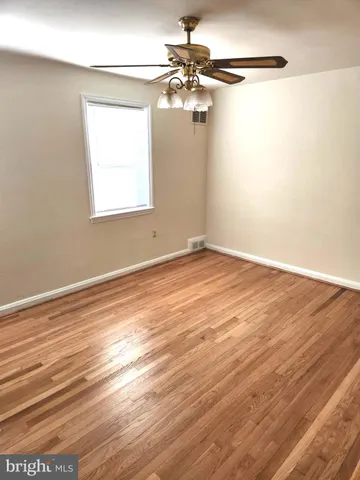 a view of a room with wooden floor and cabinet