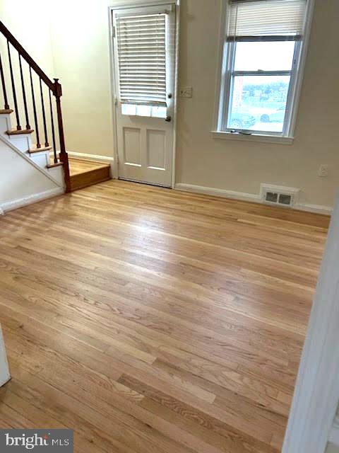 1330 Meridene Drive Baltimore, MD 21239 - Photo 4 of 15 an empty room with wooden floor and windows