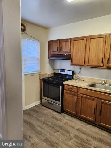 a kitchen with stainless steel appliances granite countertop a refrigerator and a stove