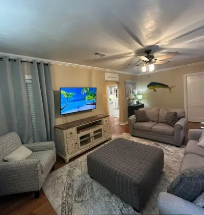 a living room with furniture and a flat screen tv