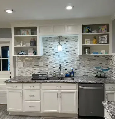 a kitchen with stainless steel appliances granite countertop a sink and cabinets
