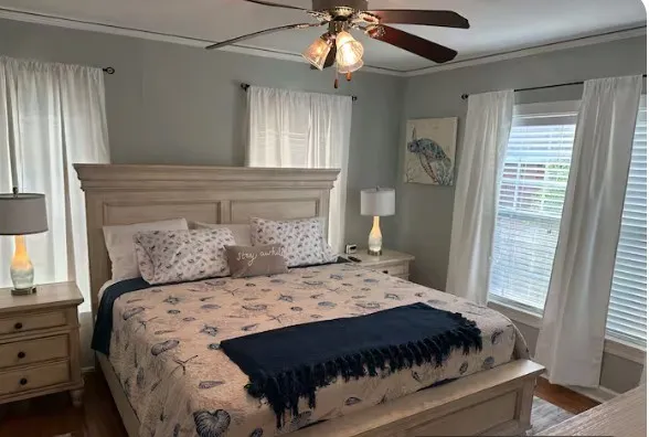 a bedroom with a large bed and a window