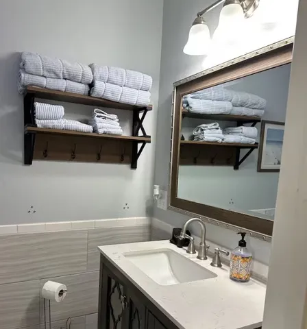 a bathroom with a sink a vanity and a mirror