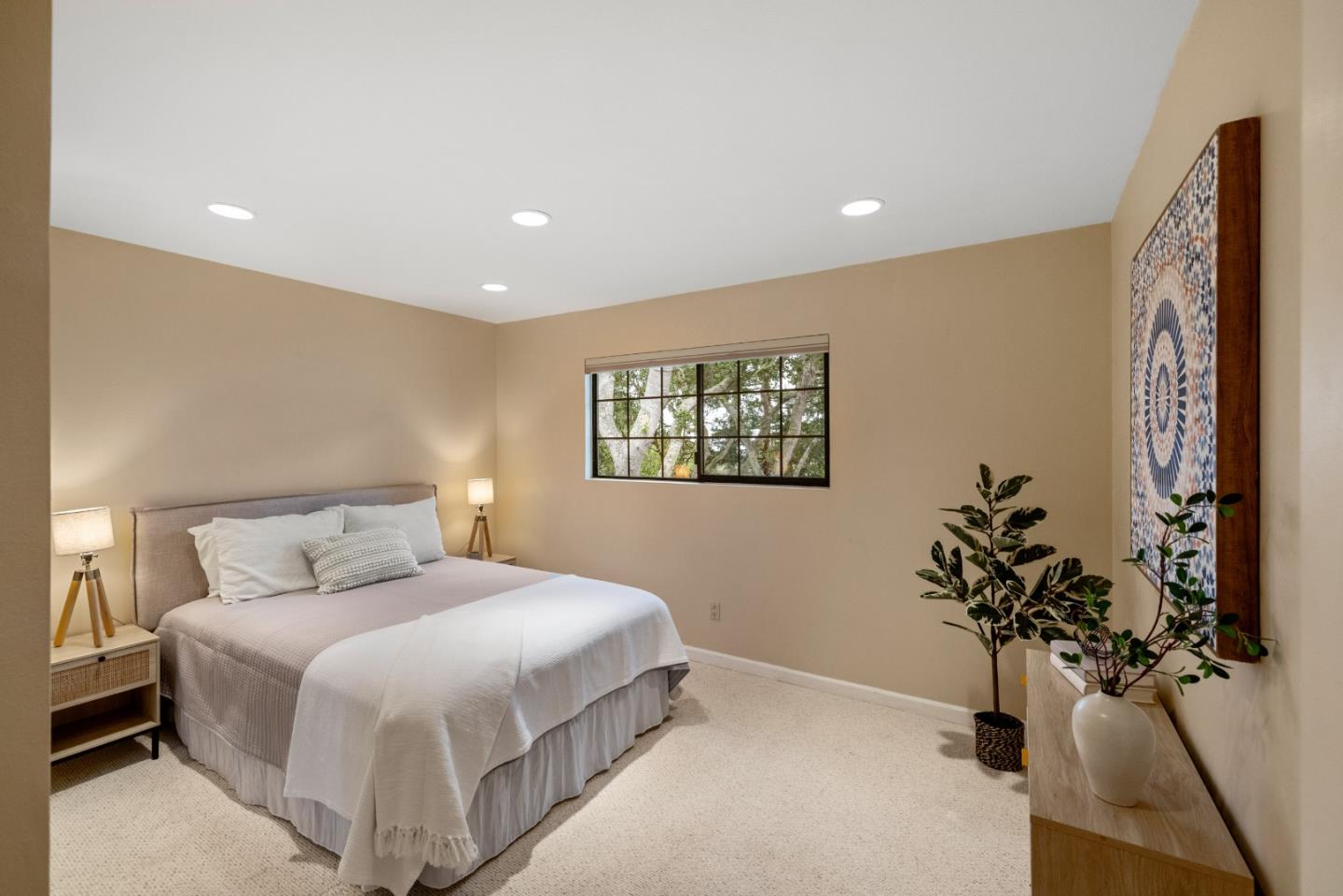 777 Parcel Street Monterey, CA 93940 - Photo 17 of 21 a bedroom with a large bed and a potted plant