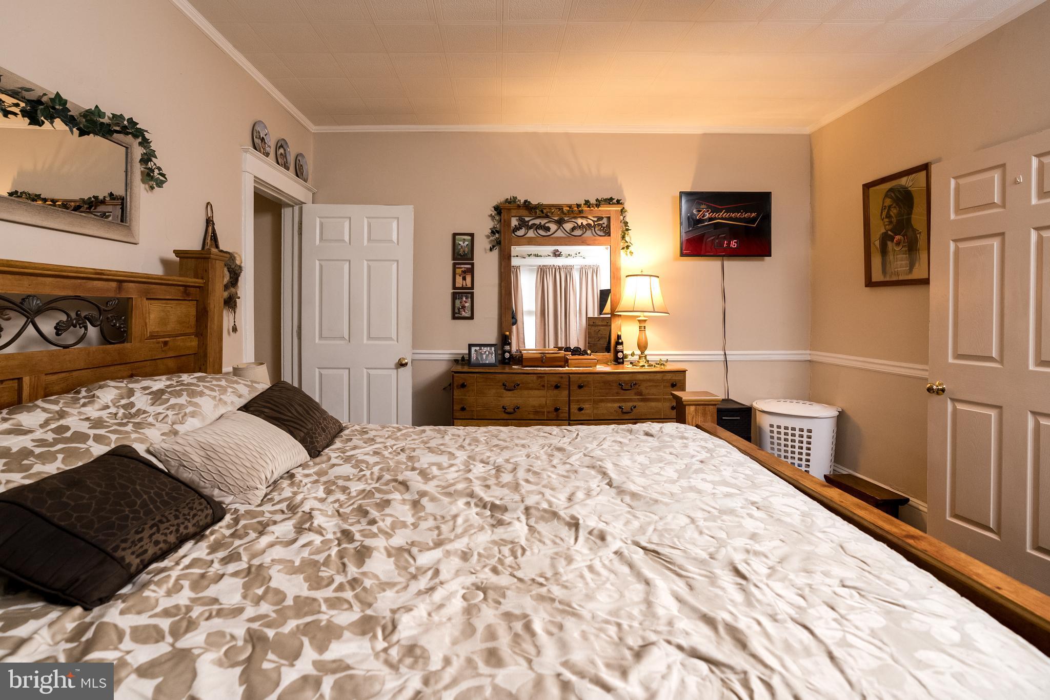 102 Ruby Street Lancaster, PA 17603 - Photo 11 of 41 a bedroom with a large bed and a flat tv screen