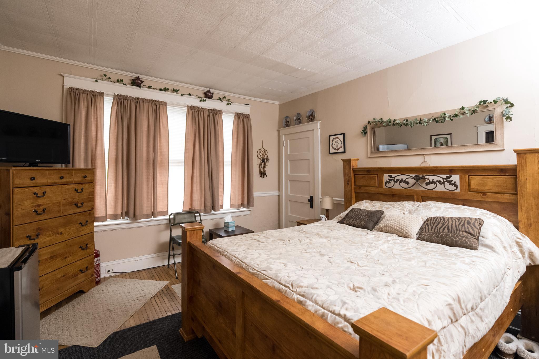 102 Ruby Street Lancaster, PA 17603 - Photo 12 of 41 a bedroom with a bed and flat screen tv