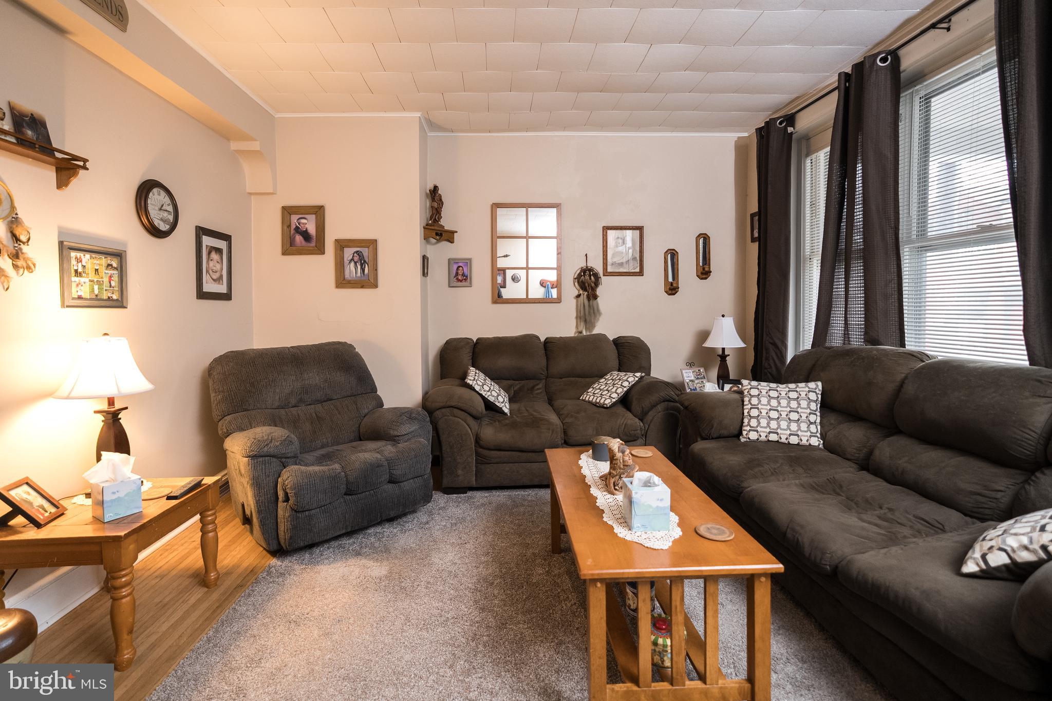 102 Ruby Street Lancaster, PA 17603 - Photo 5 of 41 a living room with furniture a large window and a flat screen tv
