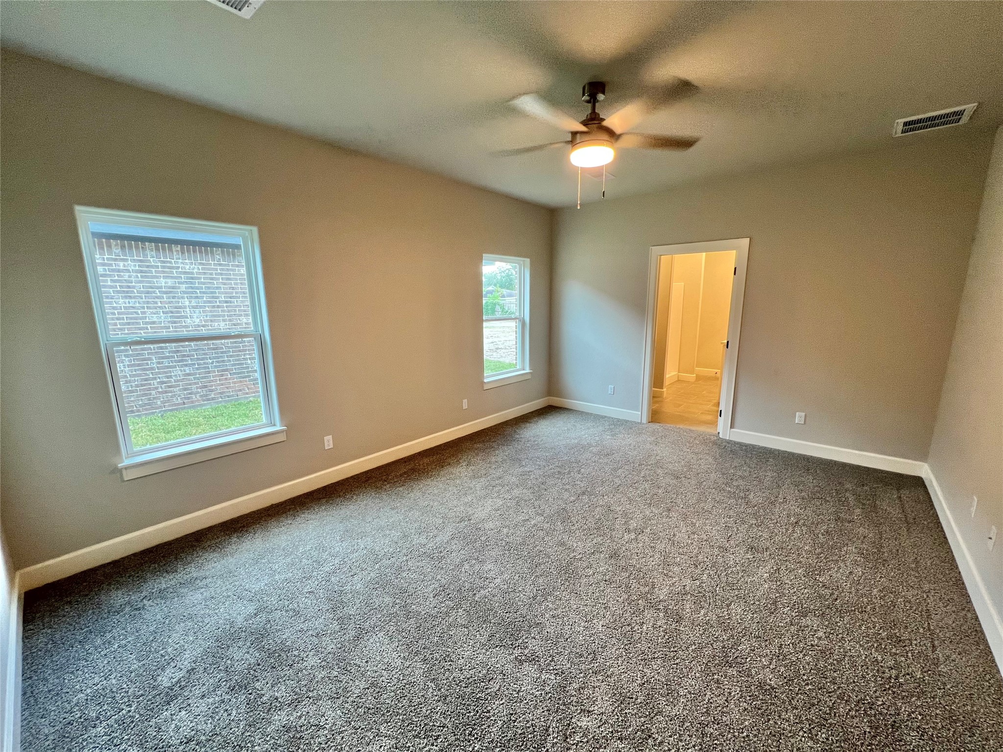 1007 South Anderson Street Angleton, TX 77515 - Photo 13 of 18 an empty room with windows and fan