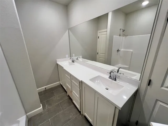 a bathroom with 2 sink and a mirror