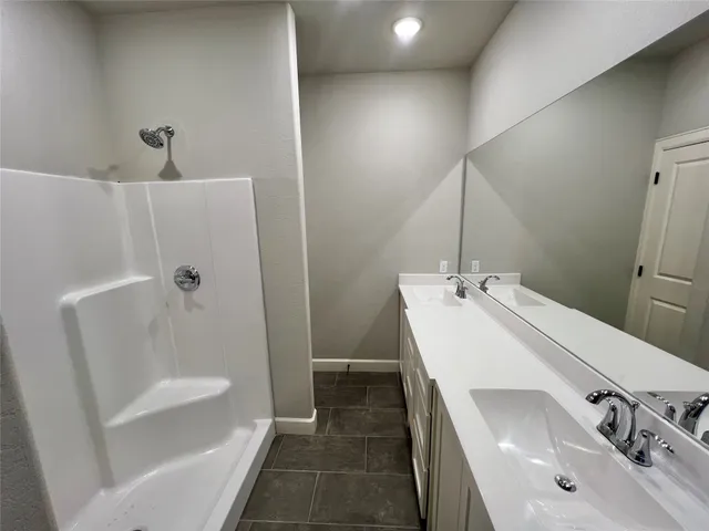a bathroom with a sink a tub and shower