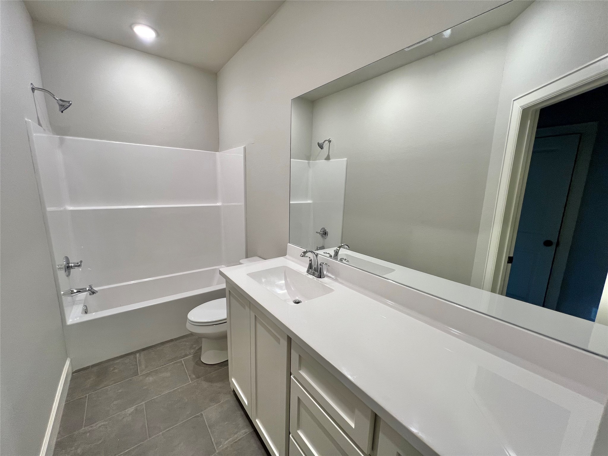 1007 South Anderson Street Angleton, TX 77515 - Photo 9 of 18 a bathroom with a sink a toilet and a bathtub