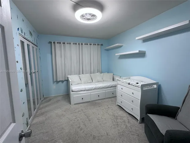 a bed sitting in a bedroom next to a window