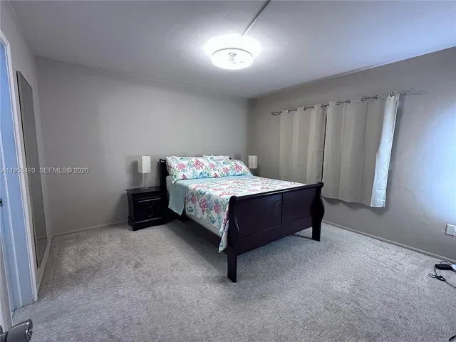 a bedroom with a bed and a table