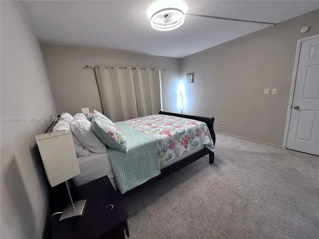 a bedroom with a bed and a lamp