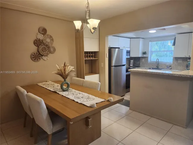 a kitchen with a sink a refrigerator and cabinets