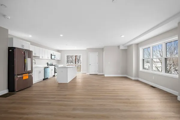 a view of kitchen with furniture and wooden floor