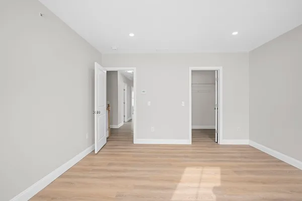 a view of a room with wooden floor and bathroom
