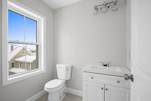 a bathroom with a toilet sink and a window
