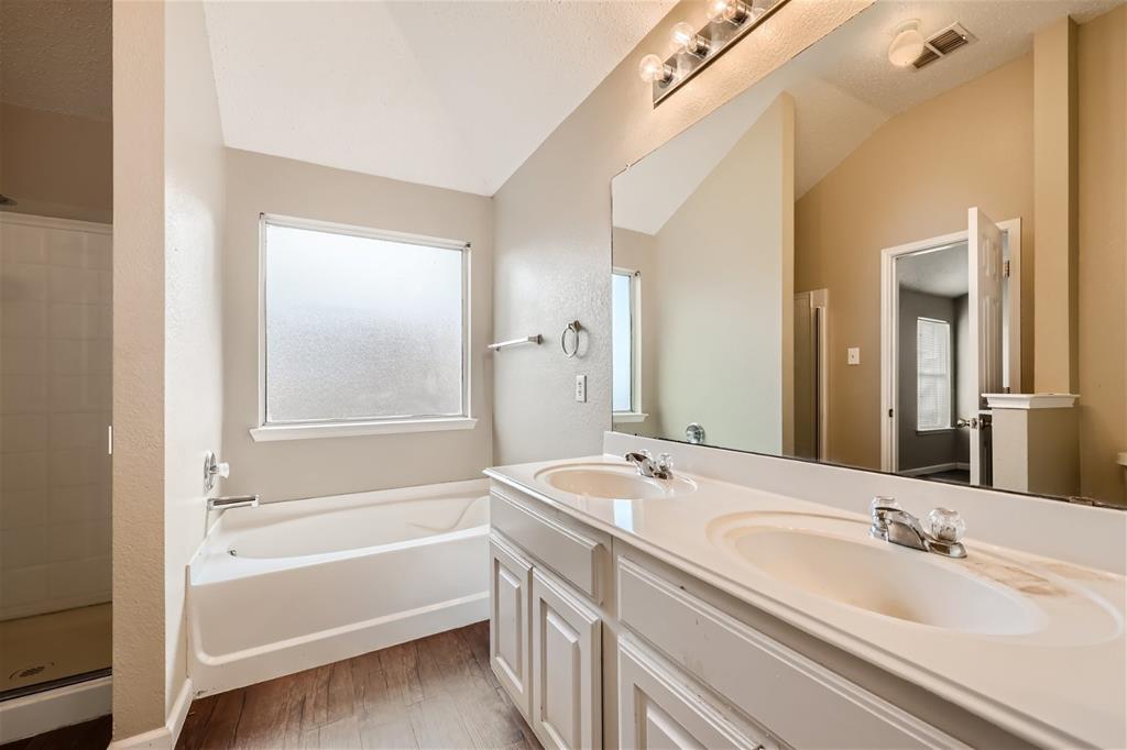 2210 Sumac Drive Forney, TX 75126 - Photo 12 of 20 a bathroom with a tub sink and mirror