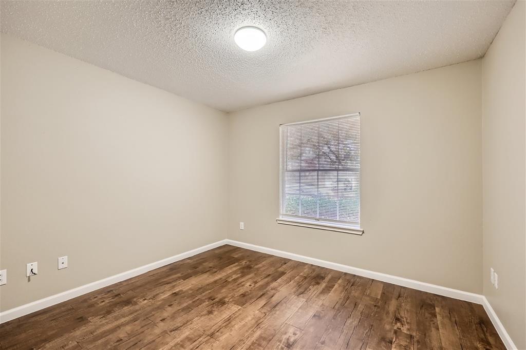 2210 Sumac Drive Forney, TX 75126 - Photo 16 of 20 an empty room with wooden floor and windows