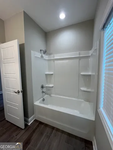 a view of hallway with wooden floor