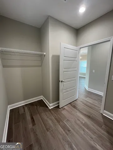 a view of a hallway with a kitchen