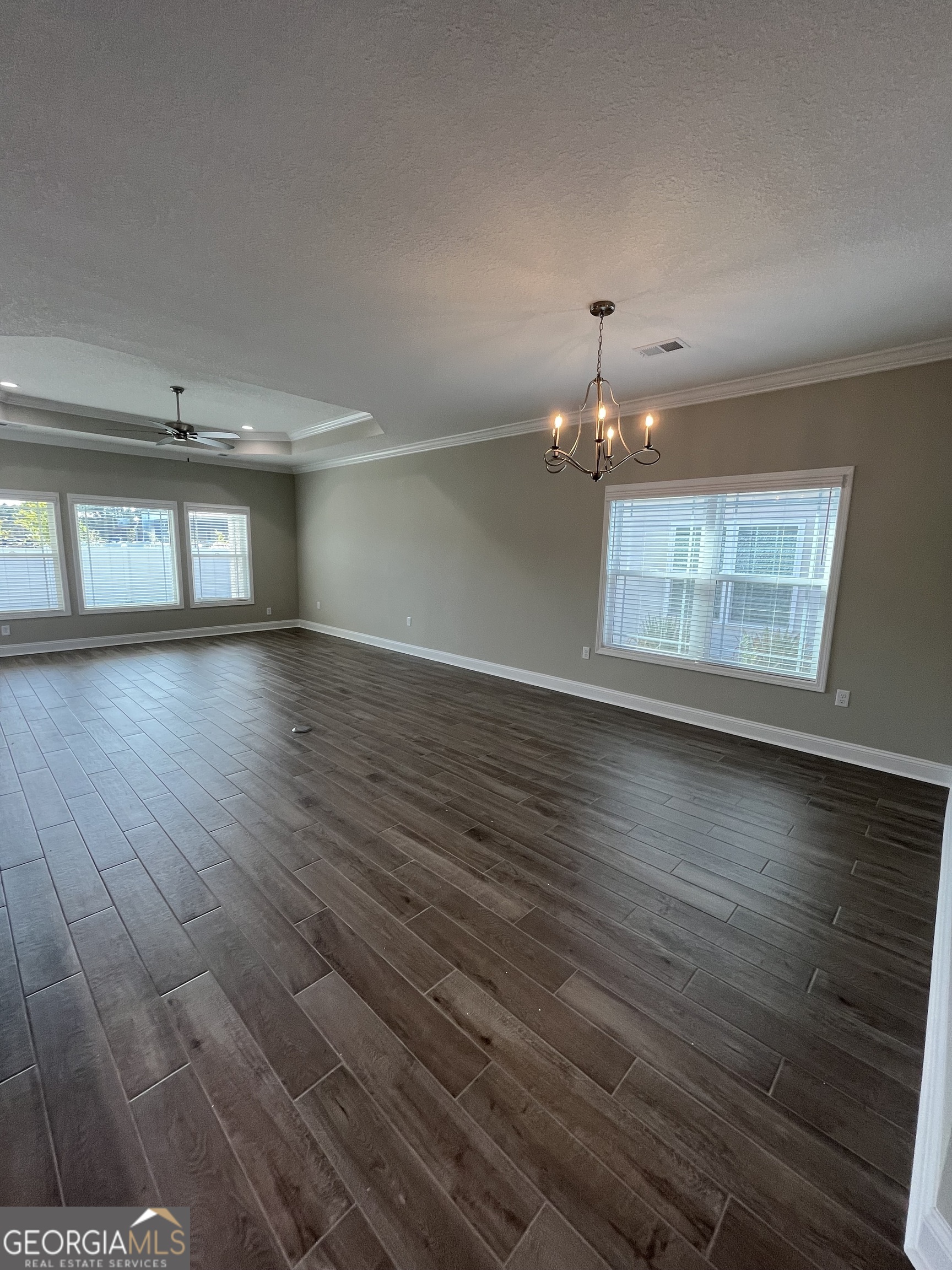 160 The Villas Way Kingsland, GA 31548 - Photo 20 of 65 an empty room with wooden floor and windows
