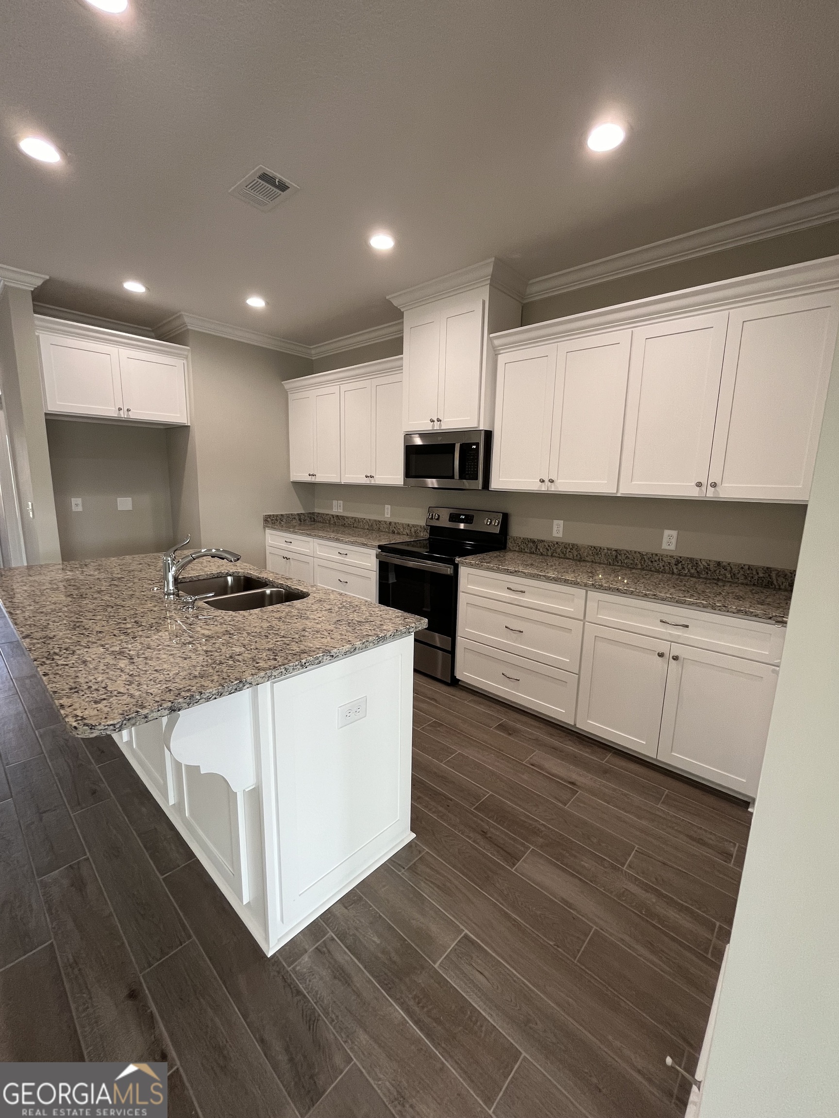 160 The Villas Way Kingsland, GA 31548 - Photo 28 of 65 a kitchen with stainless steel appliances granite countertop a stove a sink and a microwave