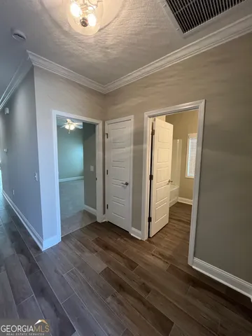 an empty room with wooden floor and closet