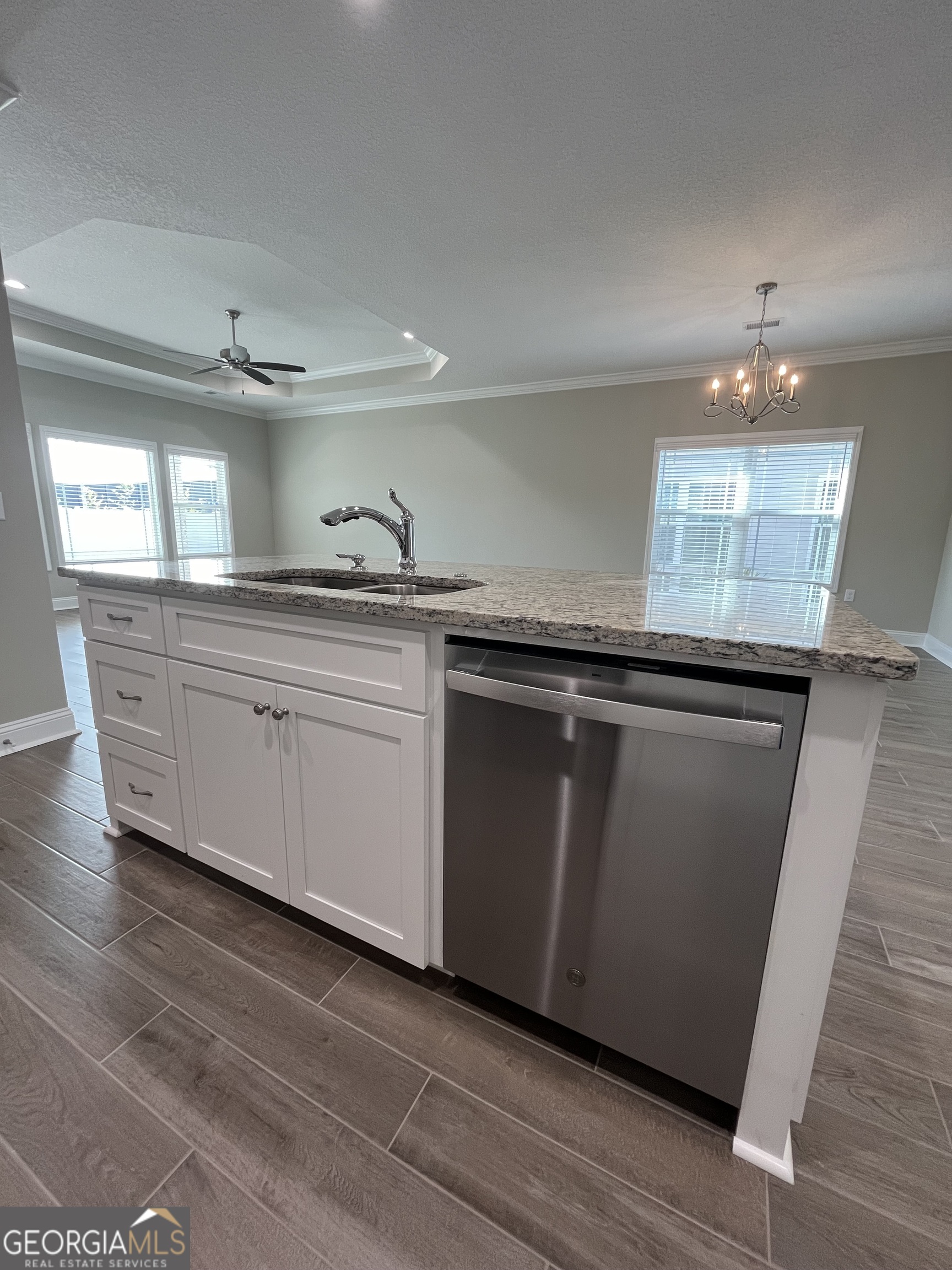 160 The Villas Way Kingsland, GA 31548 - Photo 31 of 65 a large kitchen with granite countertop a sink and dishwasher a stove top oven with wooden floor