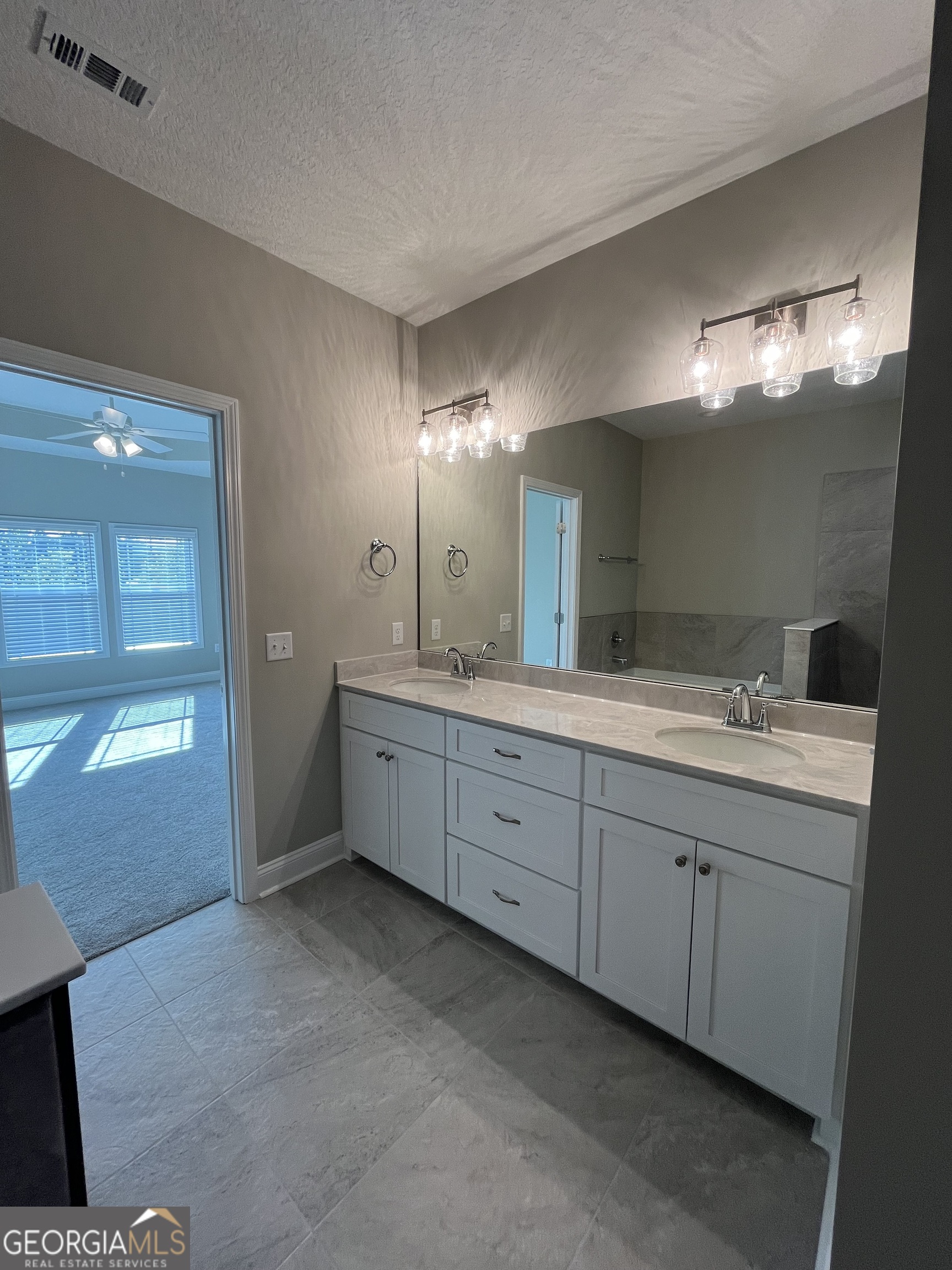 160 The Villas Way Kingsland, GA 31548 - Photo 44 of 65 a spacious bathroom with a double vanity sink and a mirror