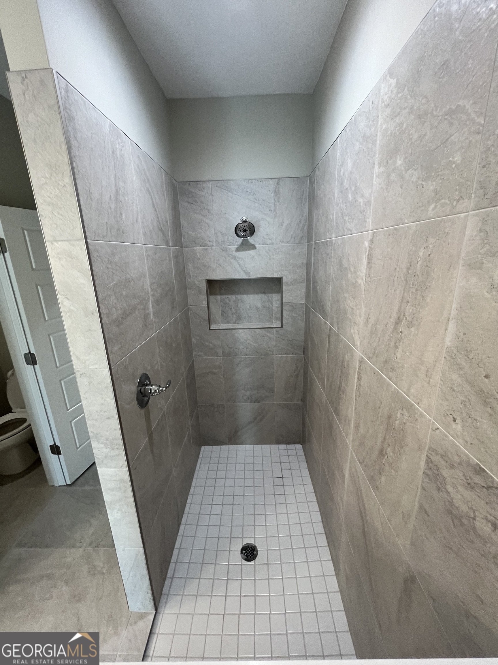 160 The Villas Way Kingsland, GA 31548 - Photo 45 of 65 a bathroom with a glass door shower