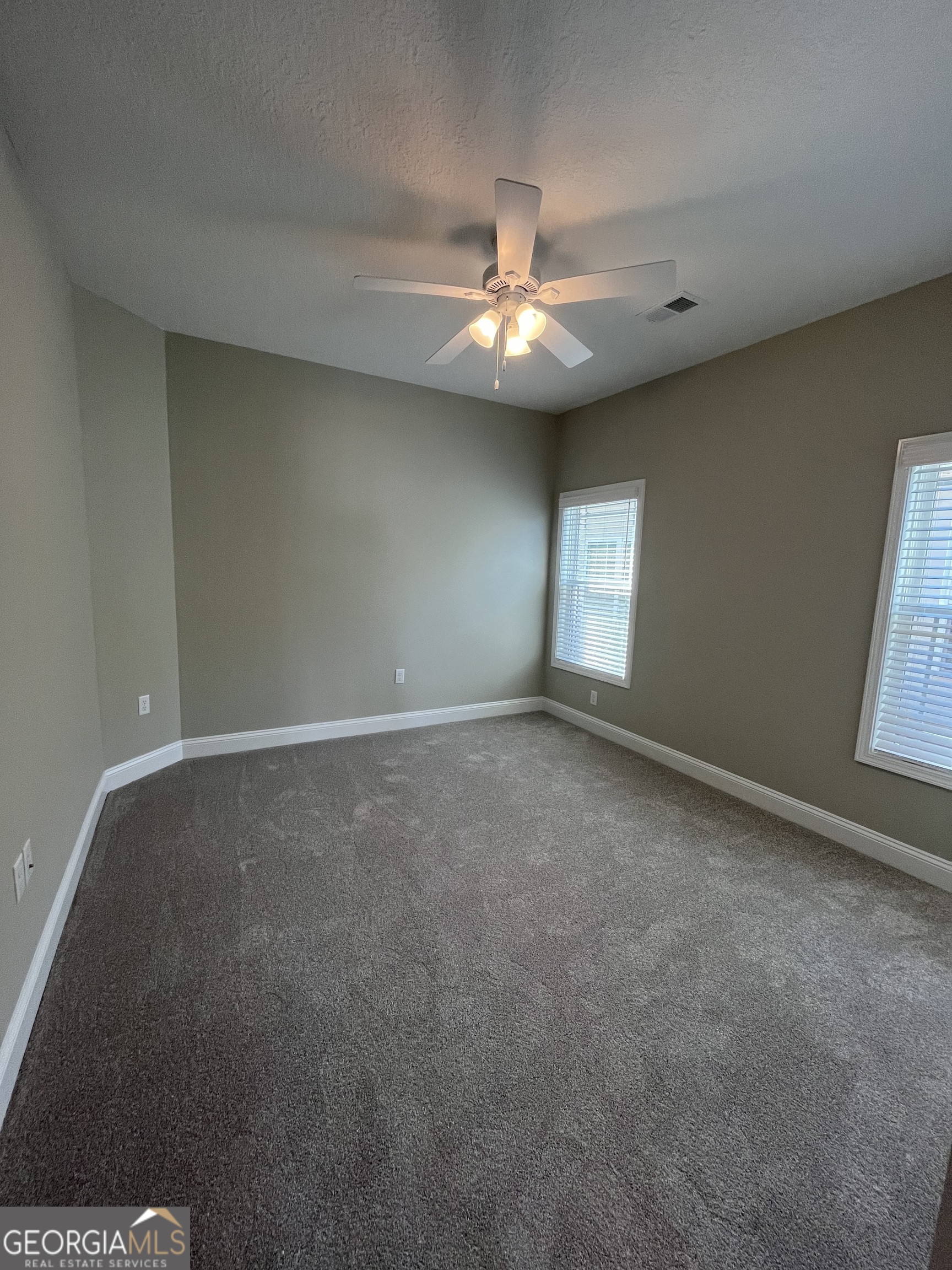 160 The Villas Way Kingsland, GA 31548 - Photo 6 of 65 en empty room with windows and ceiling fan