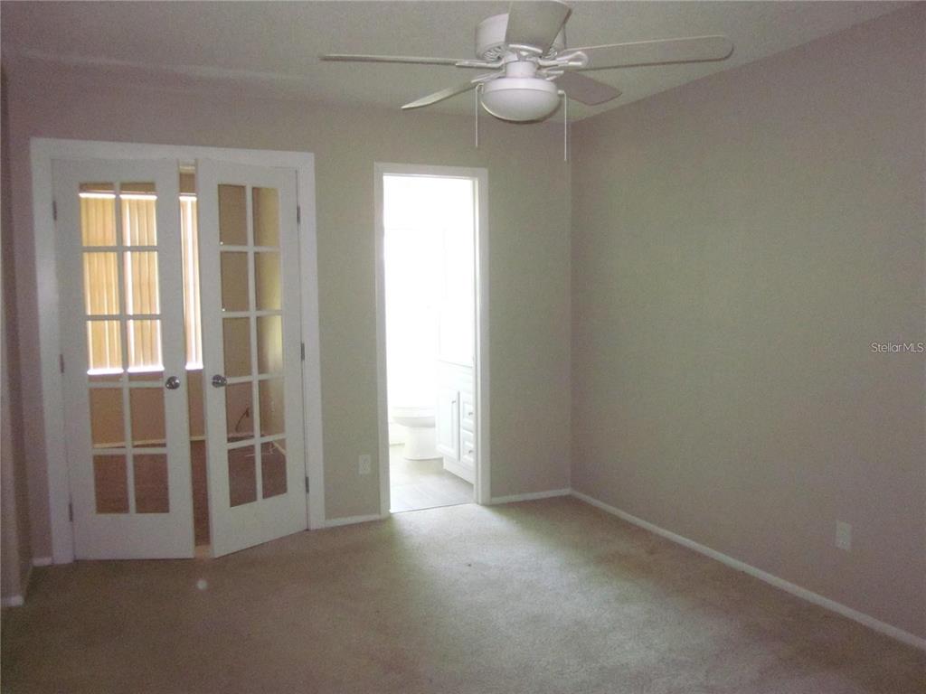 2456 Ecuadorian Way, Unit 46 Clearwater, FL 33763 - Photo 13 of 65 an empty room with windows and entrance