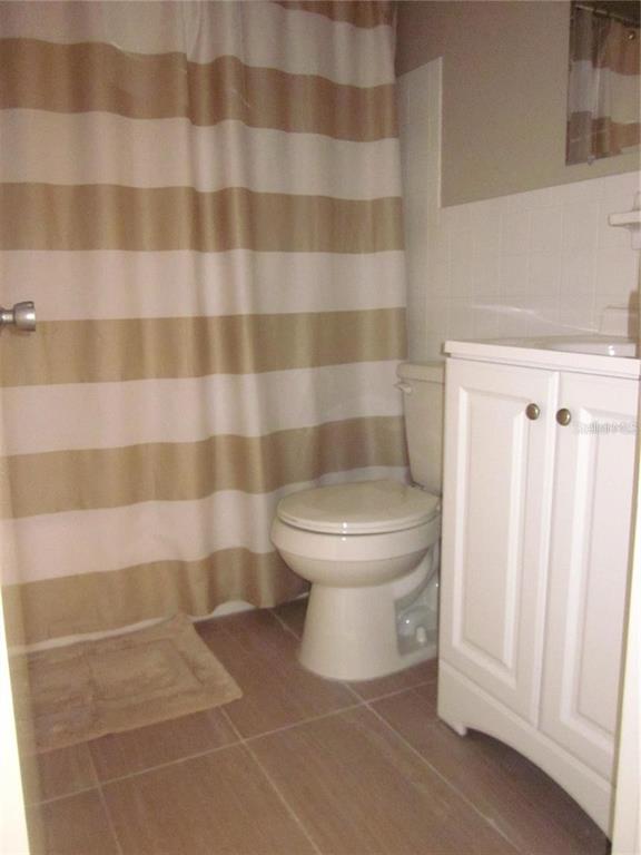 2456 Ecuadorian Way, Unit 46 Clearwater, FL 33763 - Photo 15 of 65 a white toilet sitting next to a shower curtain