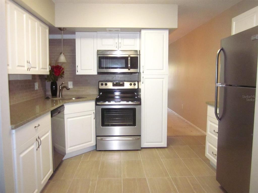 2456 Ecuadorian Way, Unit 46 Clearwater, FL 33763 - Photo 17 of 65 a kitchen with a refrigerator stove and microwave