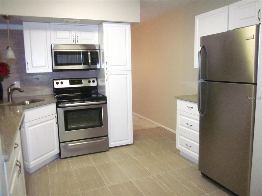 2456 Ecuadorian Way, Unit 46 Clearwater, FL 33763 - Photo 19 of 65 a kitchen with a refrigerator stove and microwave