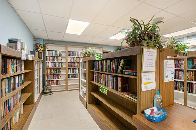 a living room with a book shelf and a book shelf