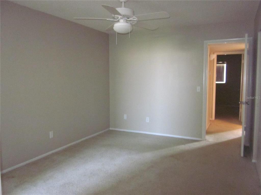 2456 Ecuadorian Way, Unit 46 Clearwater, FL 33763 - Photo 10 of 65 an empty room with a fan & a window