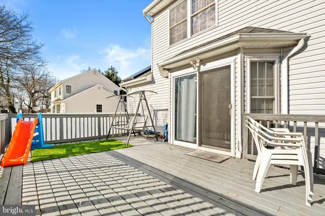 a view of a chair with a house in the background