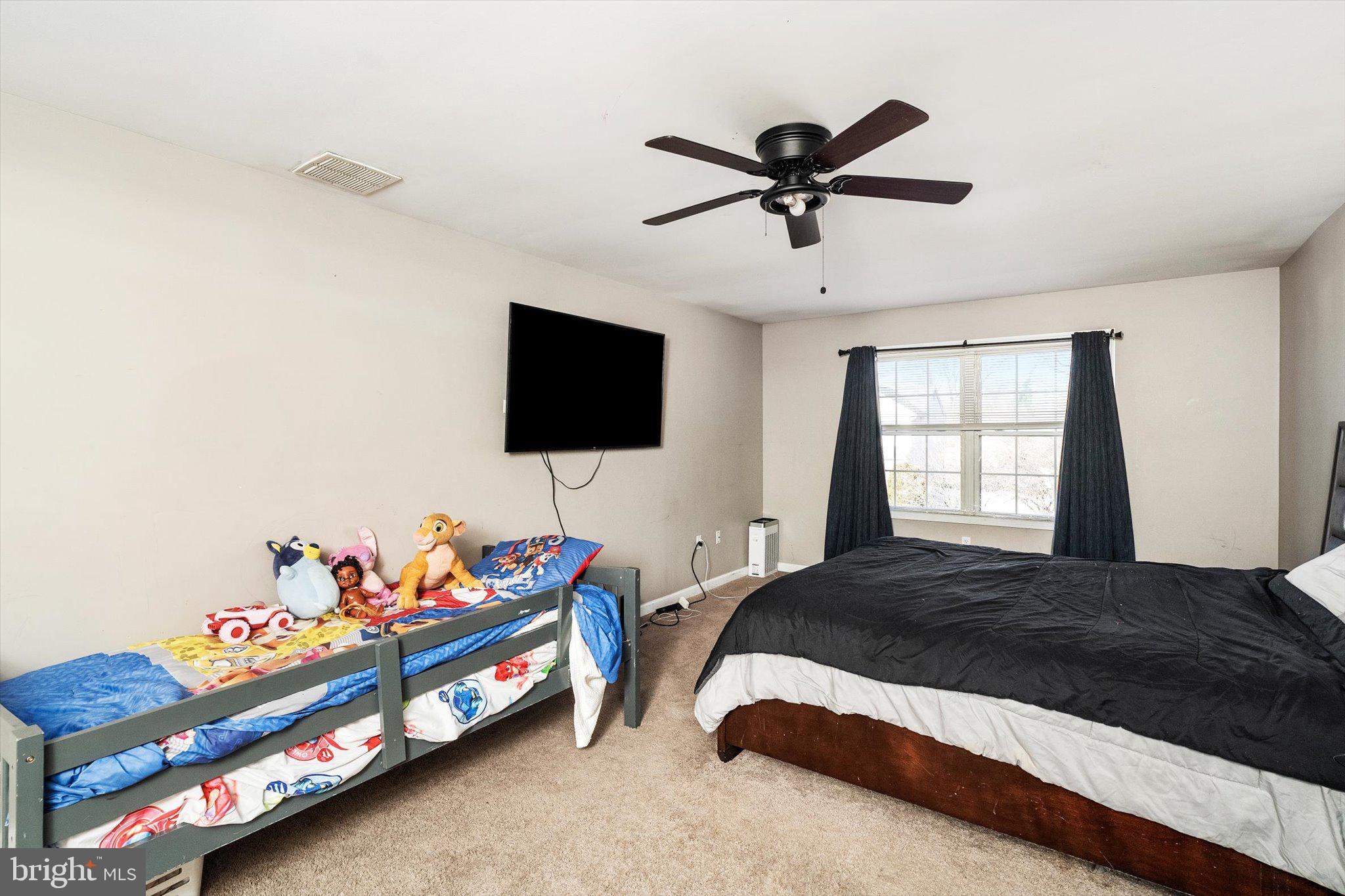 355 Leonard Avenue Hamilton, NJ 08619 - Photo 24 of 34 a bedroom with a bed and a flat screen tv