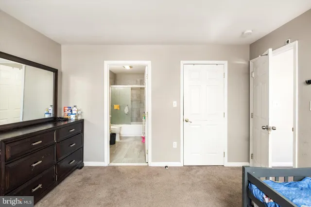 a living room with a dresser and a window