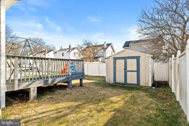 a view of a house with wooden fence