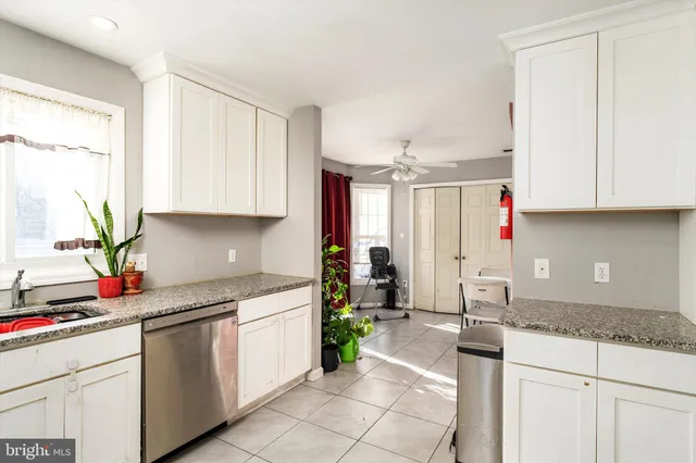 a kitchen with a sink cabinets and window