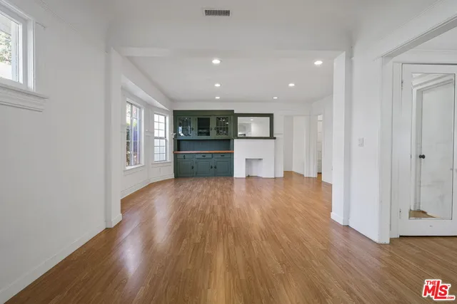 a open kitchen with window and wooden floor