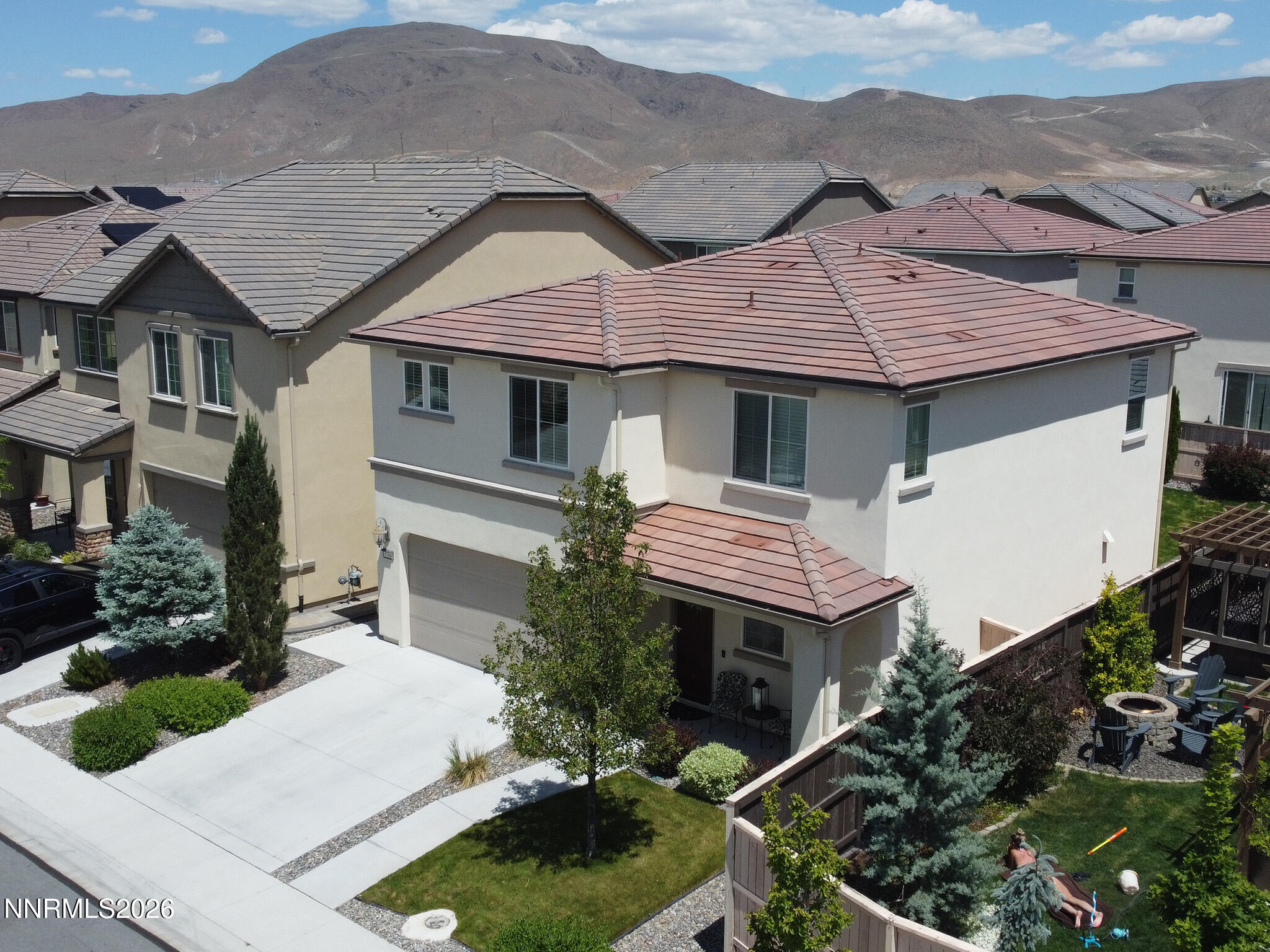 a aerial view of a house with a yard and potted plants