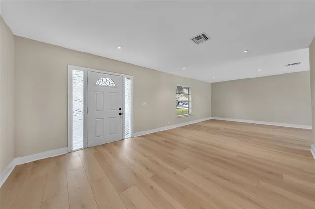 a view of a kitchen with a sink and a refrigerator