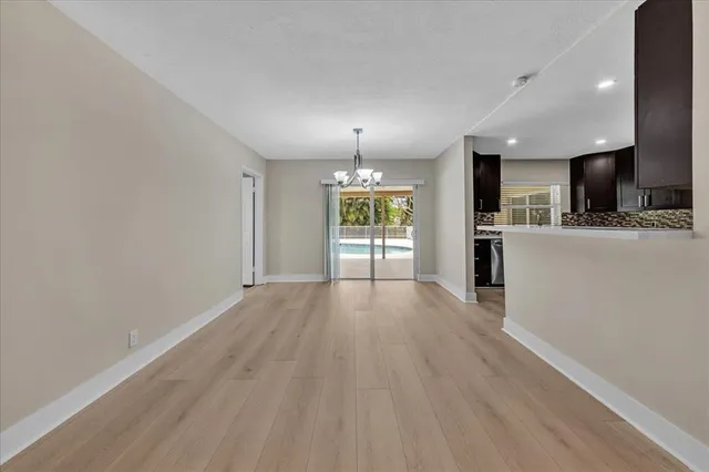a view of a room with wooden floor kitchen and living room