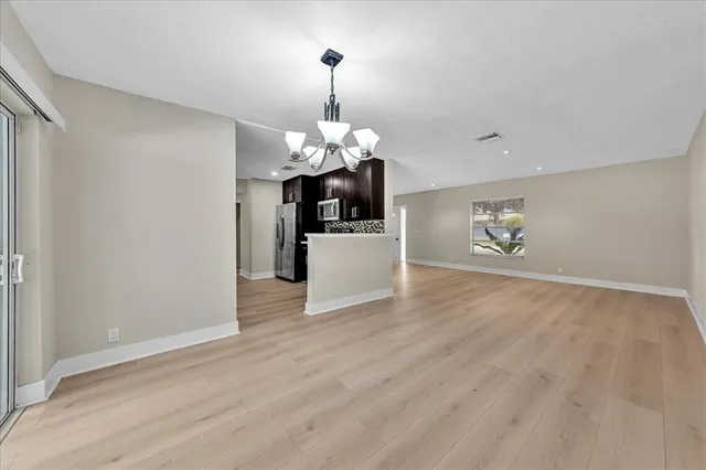 a kitchen with stainless steel appliances granite countertop wooden cabinets a refrigerator and a stove