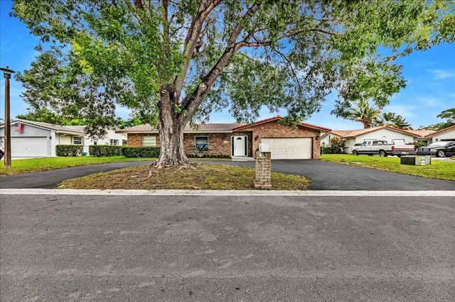 a view of house with outdoor space and tree s